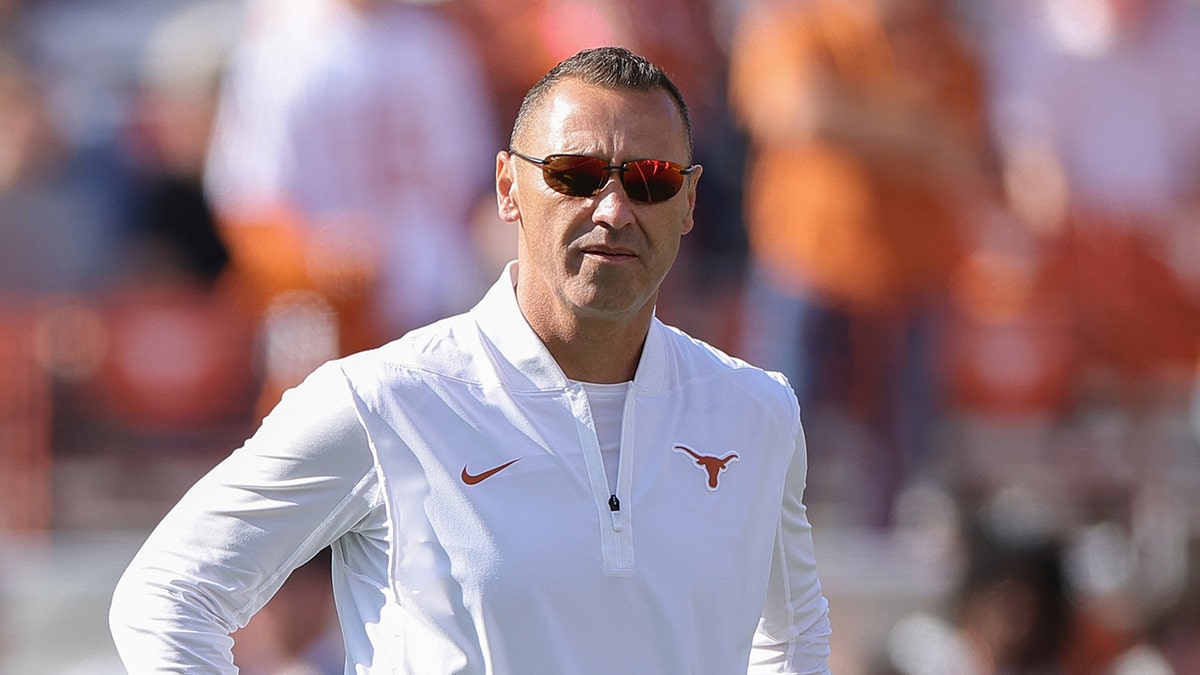 Head coach Steve Sarkisian standing on the field at Darrell K Royal-Texas Memorial Stadium