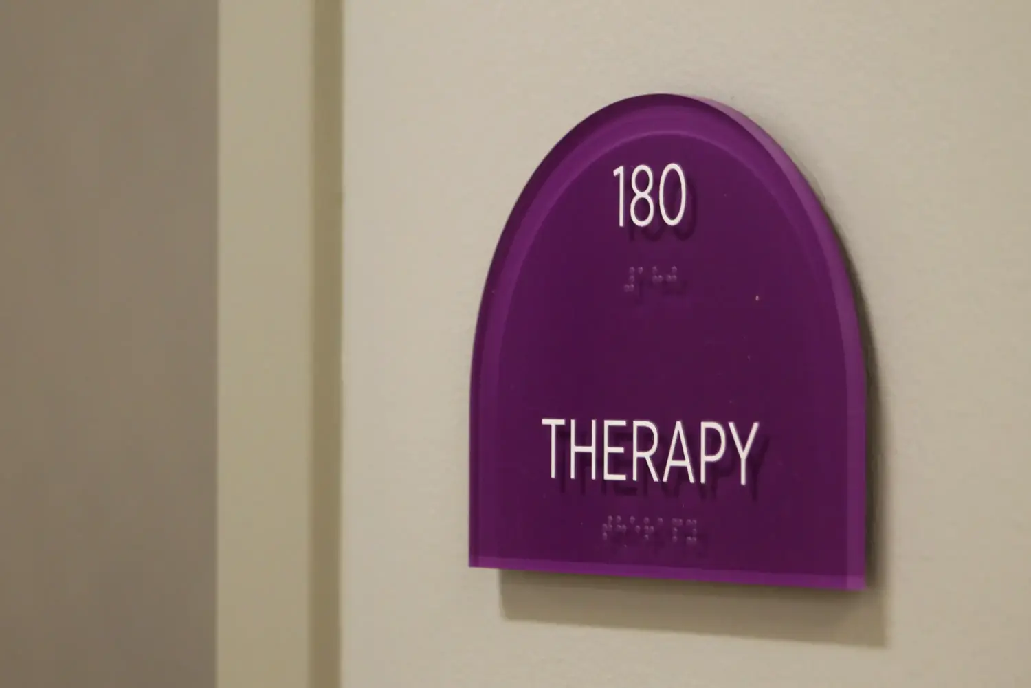 A purple sign reads "Therapy" in white block lettering.