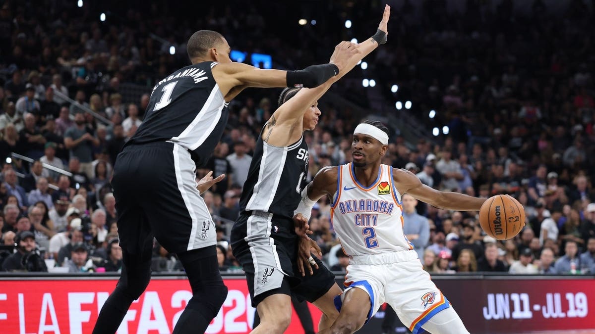 Oklahoma City Thunder's Shai Gilgeous-Alexander drives to the paint vs. the San Antonio Spurs during Game 6 of the 2026 Western Conference Finals at Frost Bank Center in Texas.