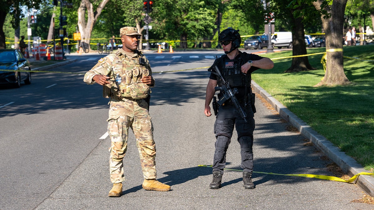 A National Guard soldier and U.S. Secret Service officer secure the crime scene.