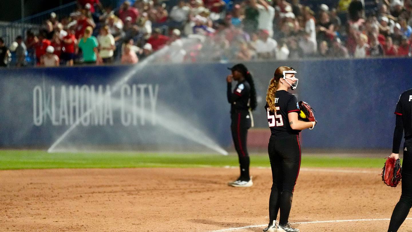 Sprinklers go off, interrupting the Women's College World Series softball game between Texas Tech Red Raiders and the UCLA Bruins at Devon Park in Oklahoma City, May 31, 2026.