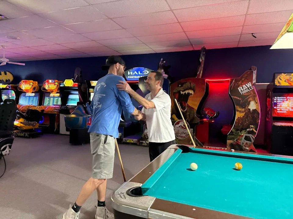 (Left)Richard Bell, the son of Terry Bell and longtime customer (right) Josh Moore shaking hands after a game of pool.
