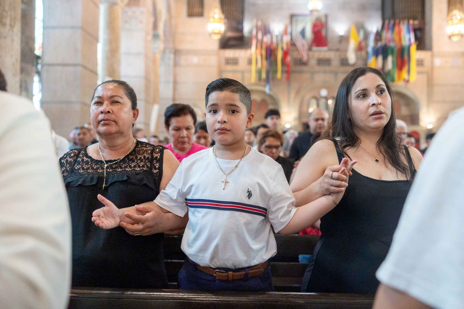 Families and parishioners pray together during the Corpus Christi Mass at the Shrine of the Sacred Heart in Washington on June 7, 2026. (Catholic Standard photo/Mihoko Owada)
