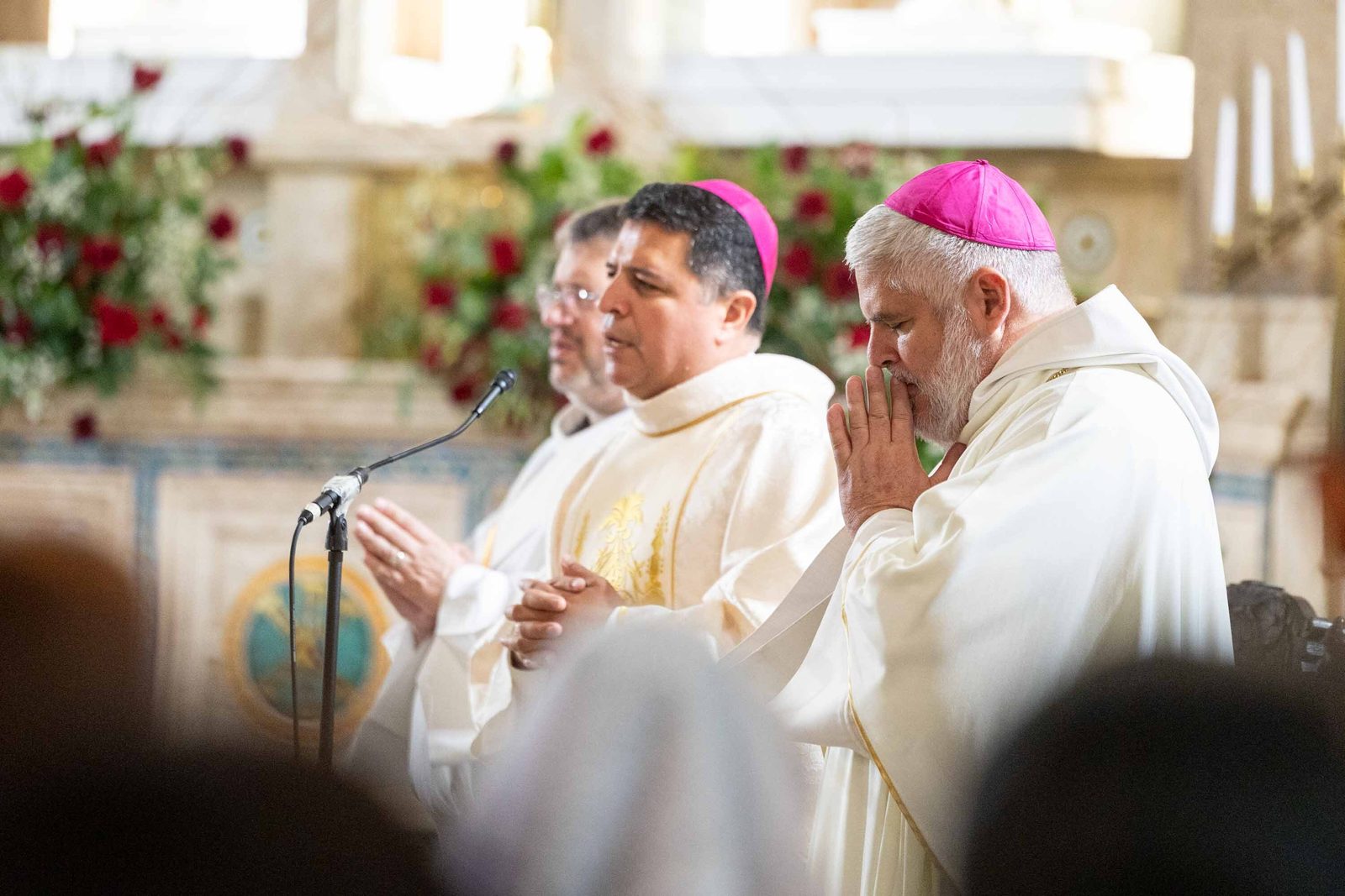 Bishop Evelio Menjívar and Bishop-elect Emilio Biosca Agüero pray together at the altar at the start of the Corpus Christi Mass on June 7 at the Shrine of the Sacred Heart in Washington, D.C. (Catholic Standard photo/Mihoko Owada)