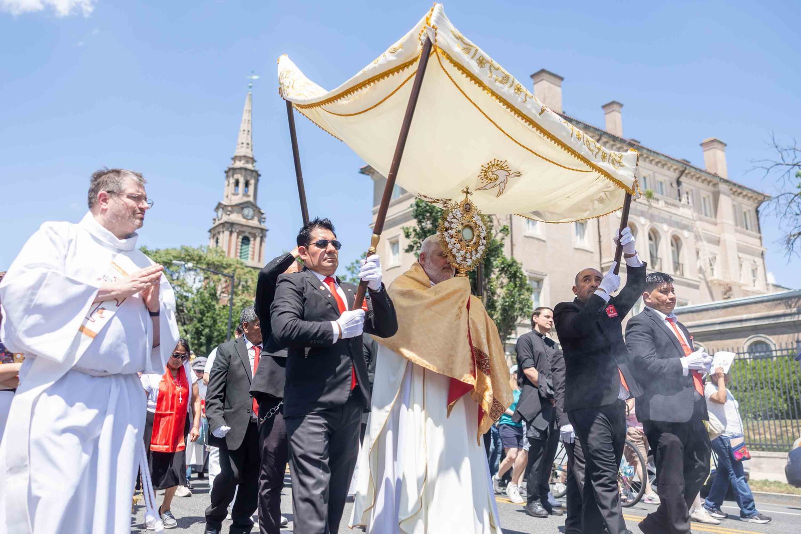 Bishop-elect Emilio Biosca Agüero carries the Blessed Sacrament during a Corpus Christi procession from the Shrine of the Sacred Heart to the Cathedral of St. Matthew the Apostle on June 7 in Washington. ( Catholic Standard Mihoko Owada)