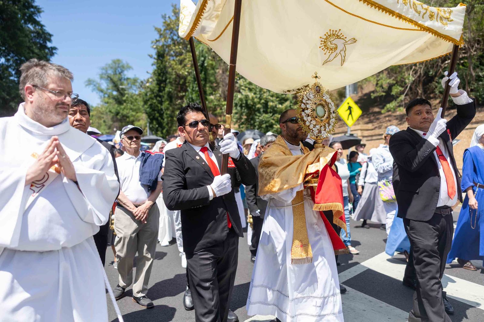 Bishop-elect Robert Boxie III carries the Blessed Sacrament during a Corpus Christi procession on June 7 from the Shrine of the Sacred Heart to the Cathedral of St. Matthew the Apostle in Washington, D.C., that was held to show prayerful support and solidarity for immigrants and refugees. On May 1, Pope Leo XIV appointed Father Boxie, the chaplain of the Sister Thea Bowman Catholic Student Center at Howard University, as a new auxiliary bishop of Washington. That day, the pope also appointed Father Gary Studniewski, the pastor of the Shrine of the Most Blessed Sacrament, as a new auxiliary bishop of Washington. Bishop-elect Boxie and Bishop-elect Studniewski will be ordained as auxiliary bishops of Washington on July 7 at the Basilica of the National Shrine of the Immaculate Conception. (Catholic Standard photo by Mihoko Owada)