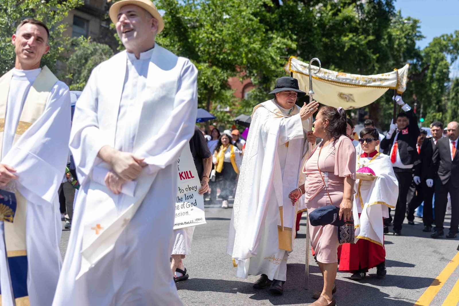 Bishop Evelio Menjivar blesses a woman during a Corpus Christi procession held in solidarity with immigrants on June 7 in Washington. The procession traveled from the Shrine of the Sacred Heart to the Cathedral of St. Matthew the Apostle. (Catholic Standard photo by Mihoko Owada)