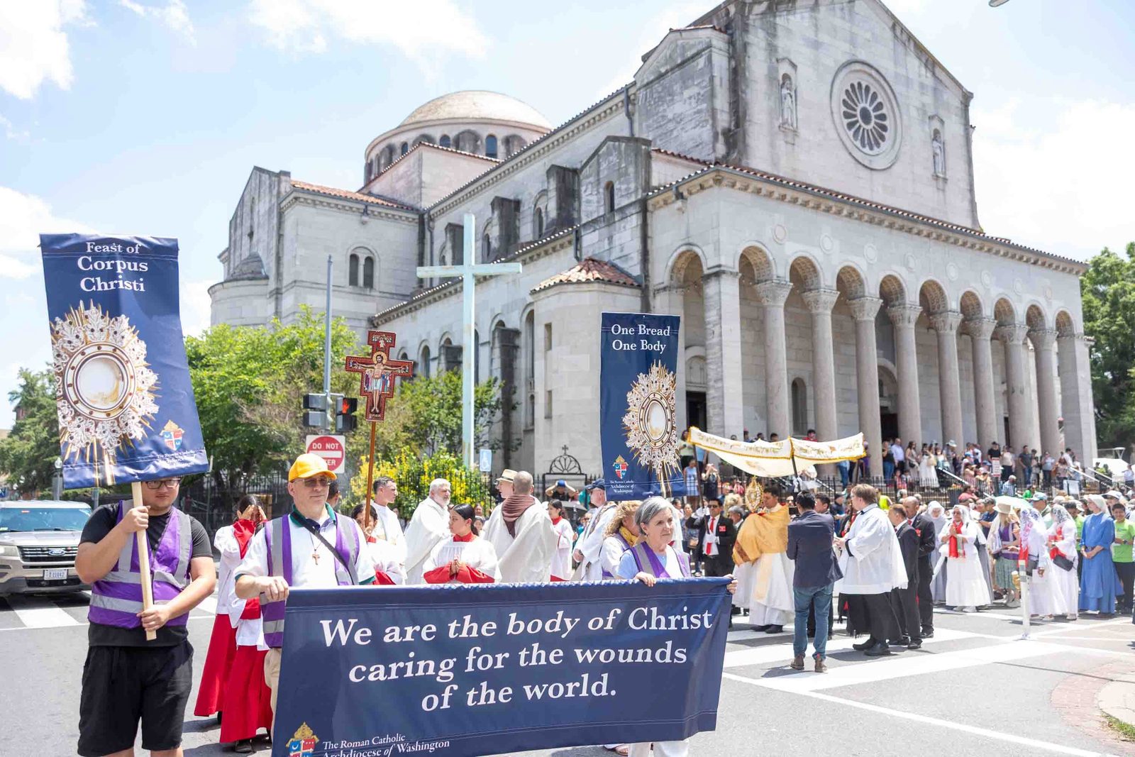 Bishop Evelio Menjívar carries the Blessed Sacrament as he leads a Corpus Christi procession from the Shrine of the Sacred Heart to the Cathedral of St. Matthew the Apostle in Washington on June 7, 2026, as the faithful gathered to honor the Solemnity of the Most Holy Body and Blood of Christ in solidarity with immigrants and refugees. (Catholic Standard photo/Mihoko Owada)