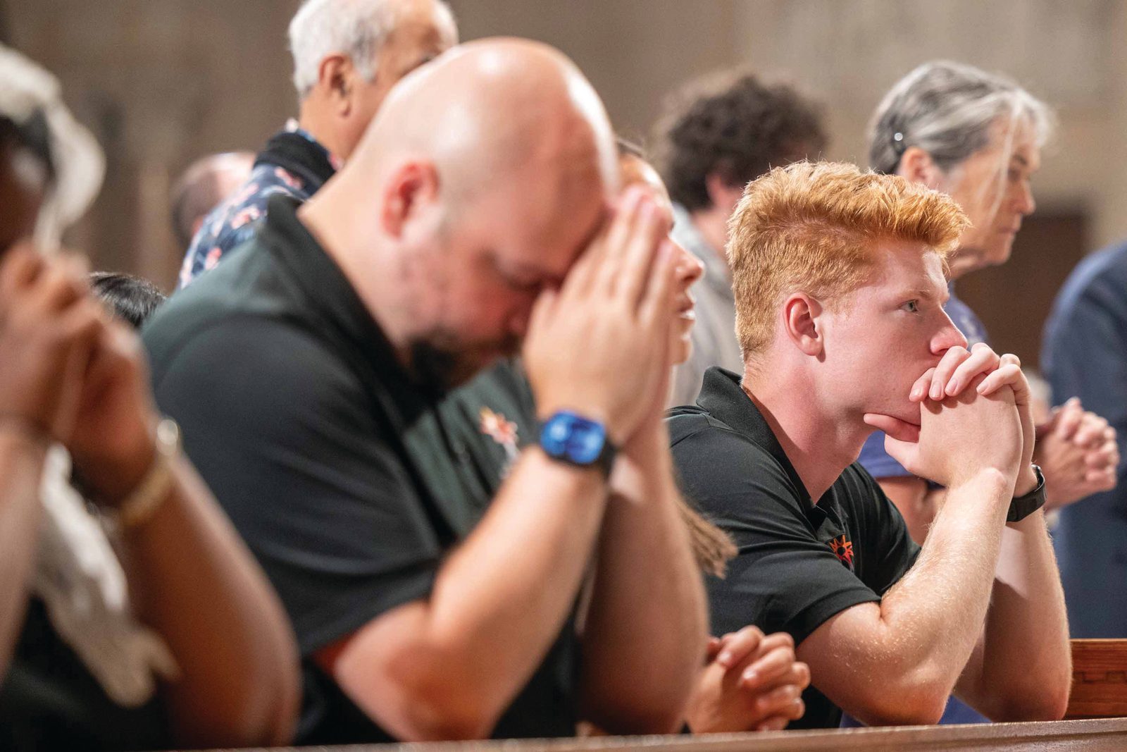 Zachary Dotson and John Paul Flynn, two of the nine young adult “perpetual pilgrims” traveling with the Eucharist along the East Coast during the 2026 National Eucharistic Pilgrimage, pray during a Vigil Mass for the Solemnity of the Most Holy Body and Blood of Christ on June 6 at the Basilica of the National Shrine of the Immaculate Conception. (Catholic Standard photo by Mihoko Owada)