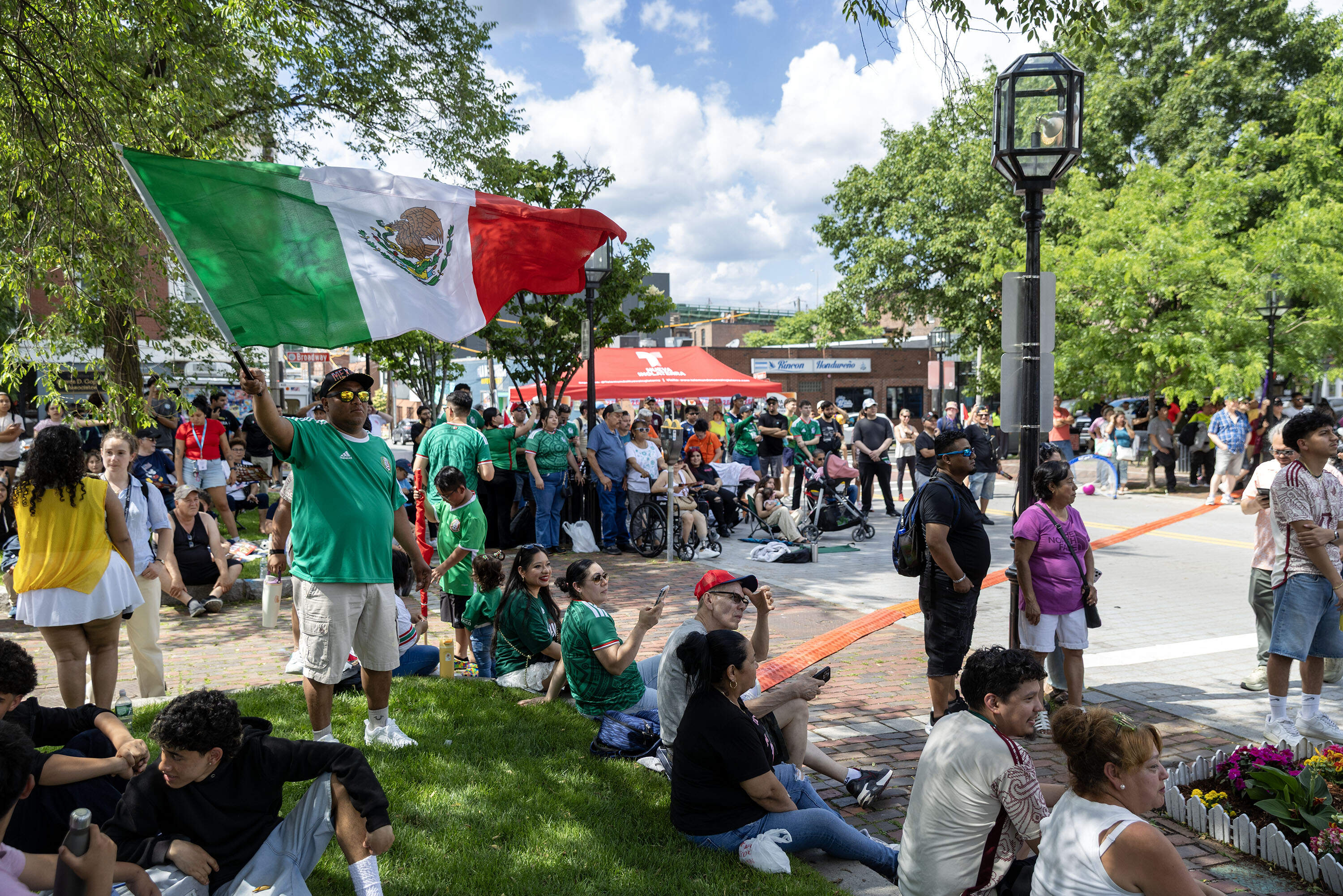 A fan waves the Mexican flag at the Fiesta Fútbol. (Robin Lubbock/WBUR)