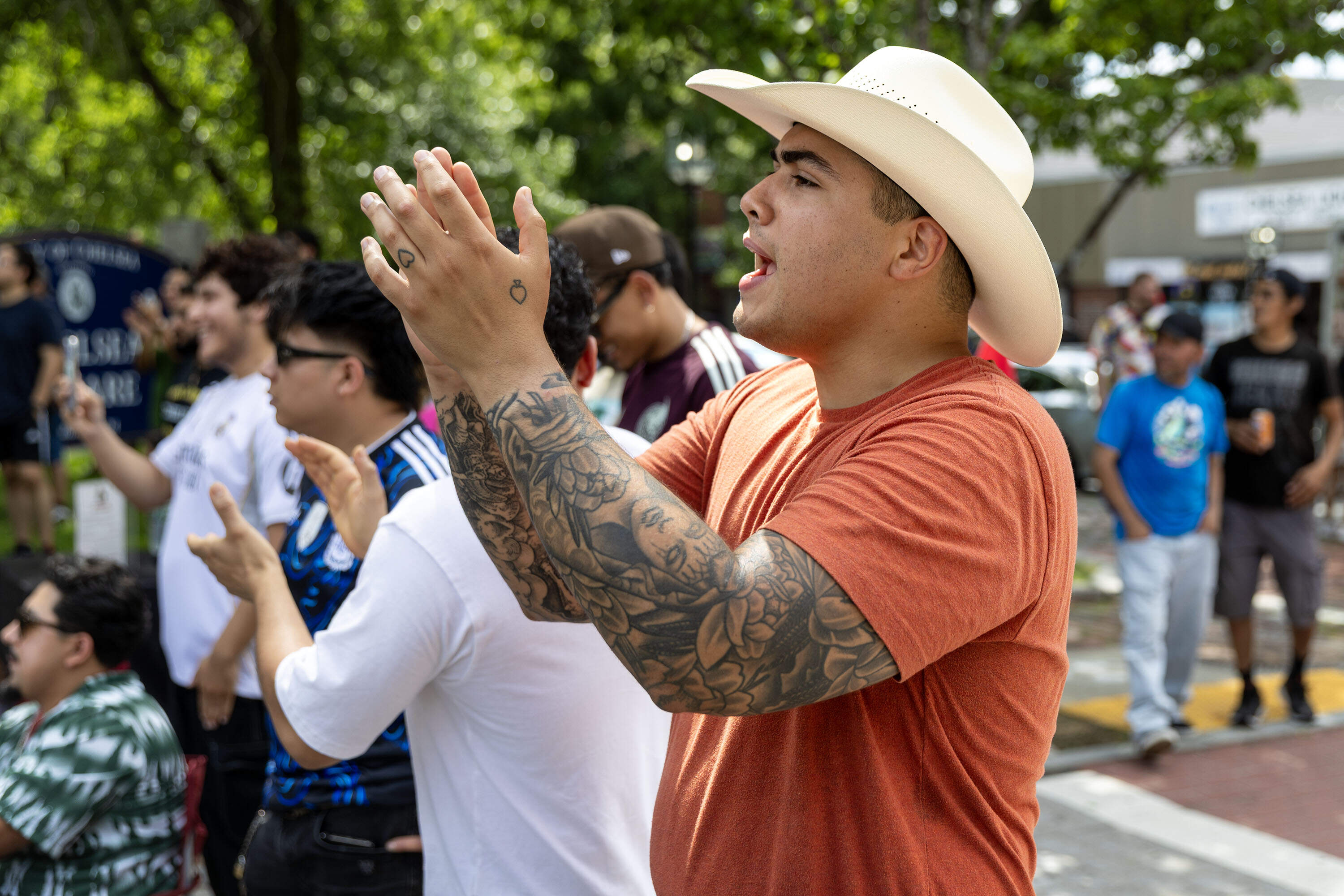 A fan cheers on his team at the watch party in Chelsea Square. (Robin Lubbock/WBUR)