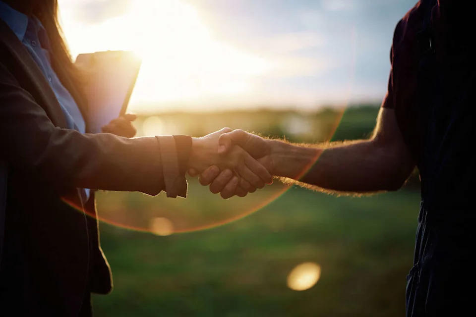 A new survey by Advance Funds Network claims that Kerrville, Fredericksburg and Brenham are home to Texas' most trusted business owners. The photo shows two people shaking hands in a field. (Drazen Zigic/Getty Images)