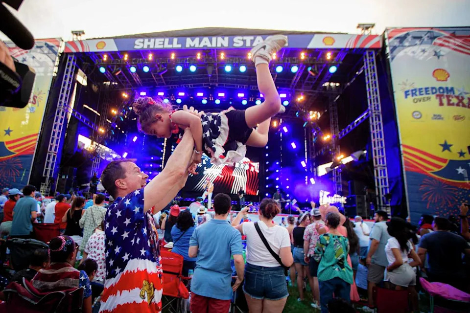 Michael Swearingen, left, and his daughter Violet listen to music during the annual Freedom Over Texas festival on the Fourth of July, Thursday, July 4, 2024, in Houston. (Ishika Samant/Staff photographer)