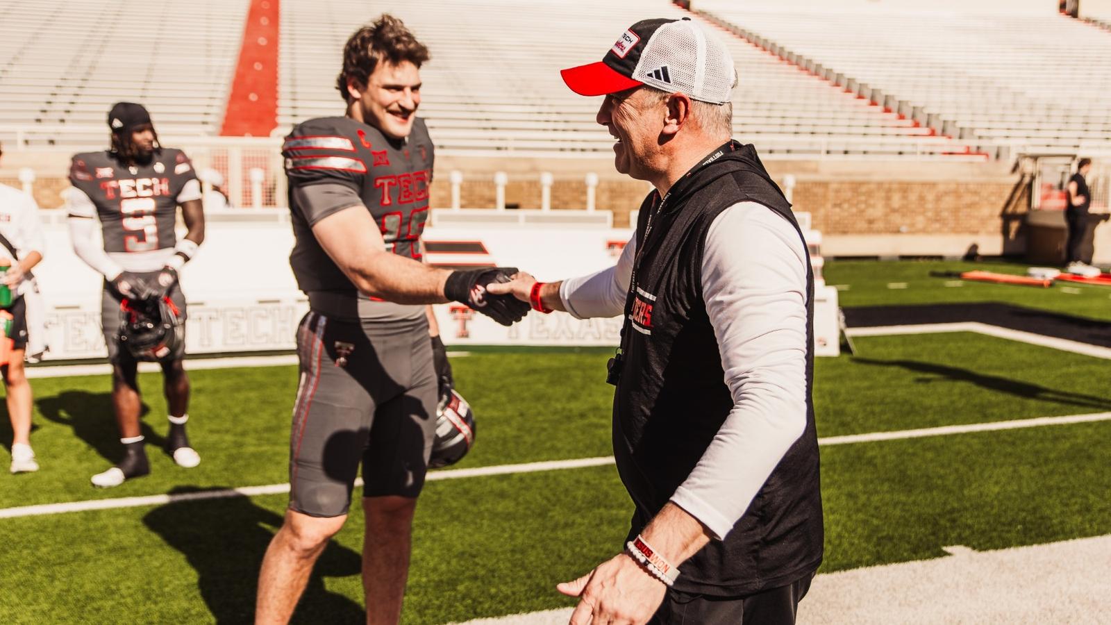 Mike Leach archived photo following a Texas Tech win at Texas A&M with cameras surrounding him postgame.
