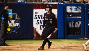 Jasmyn Burns celebrates while running the bases after hitting a home run against Alabama in the Women's College World Series.