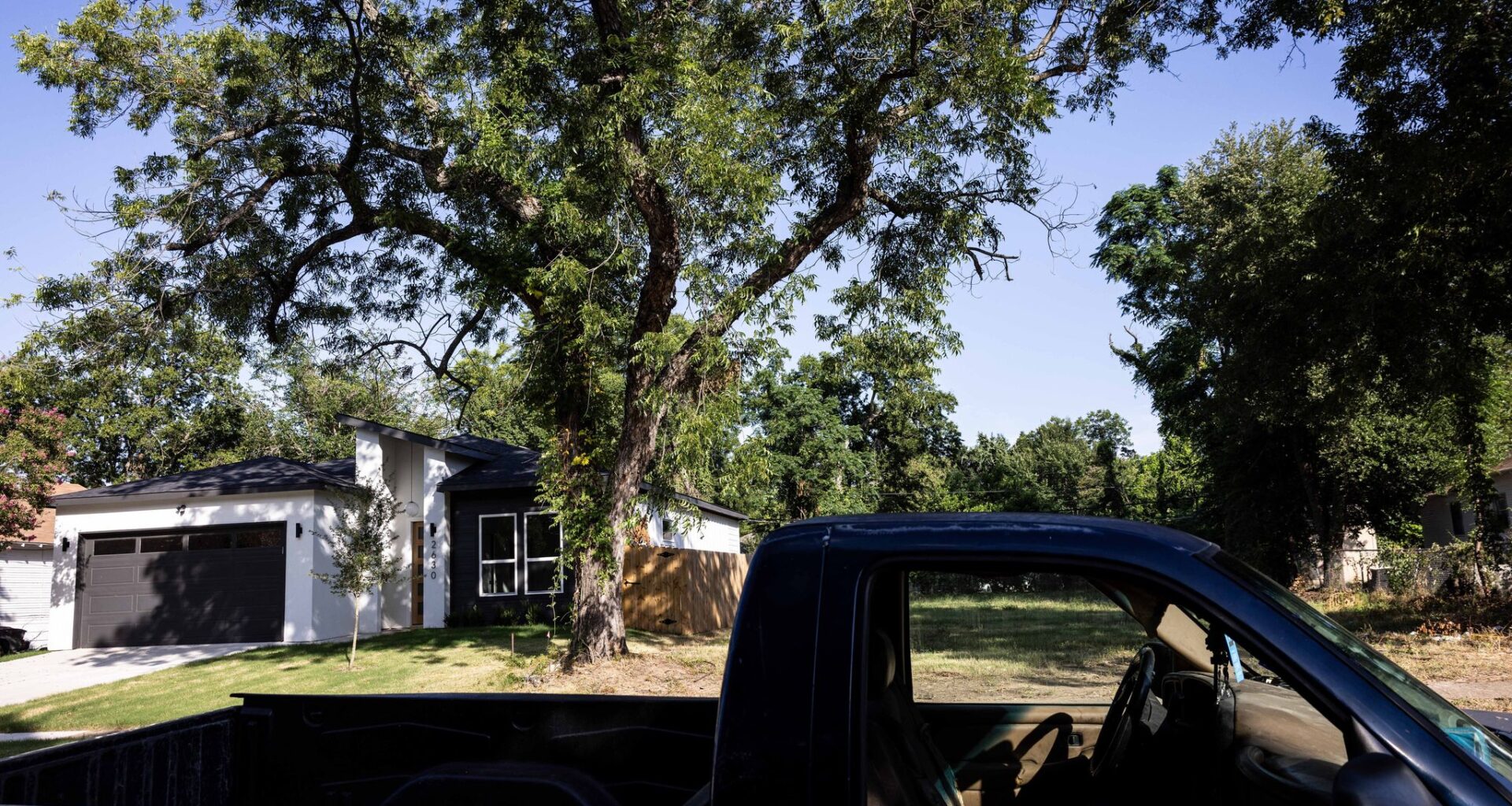 A contemporary house sits vacant across from Alvin Mouton's home on Warren Avenue on July 7, 2025, in Dallas. Mouton said he likes the style and build of the new home in the Queen City neighborhood.