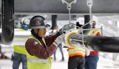 Construction workers build out the rooftop chillers and water lines feeding them atop Dallas TX4, which is under construction at the NTT Data center campus in Garland, Texas, March 4, 2026. It will take 40 of those water-filled chillers to cool the fourth data center built on the property.