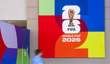 A person passes a banner before opening ceremonies for the  FIFA World Cup 2026 International Broadcast Center (IBC) at the Kay Bailey Hutchison Convention Center, Monday, June 1, 2026, in Dallas.