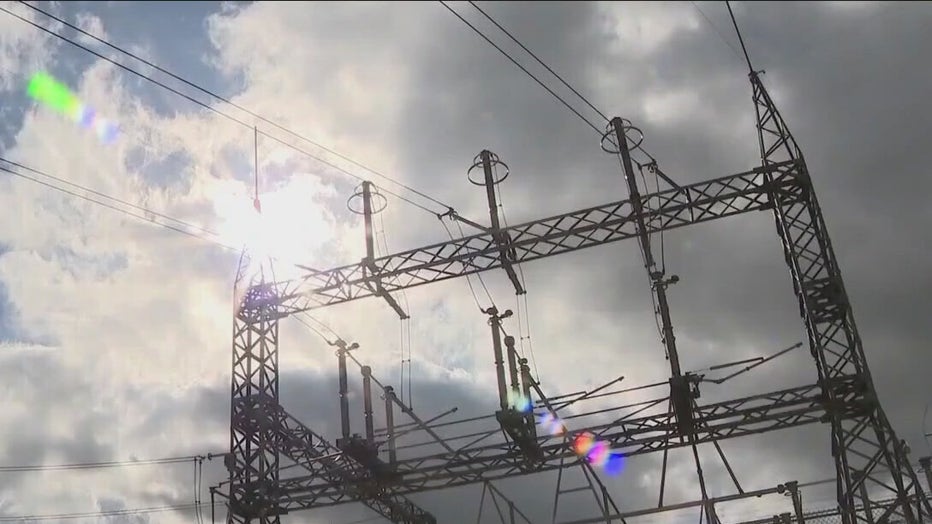 Sun shines through clouds over a power substation in Austin, Texas, in 2022.