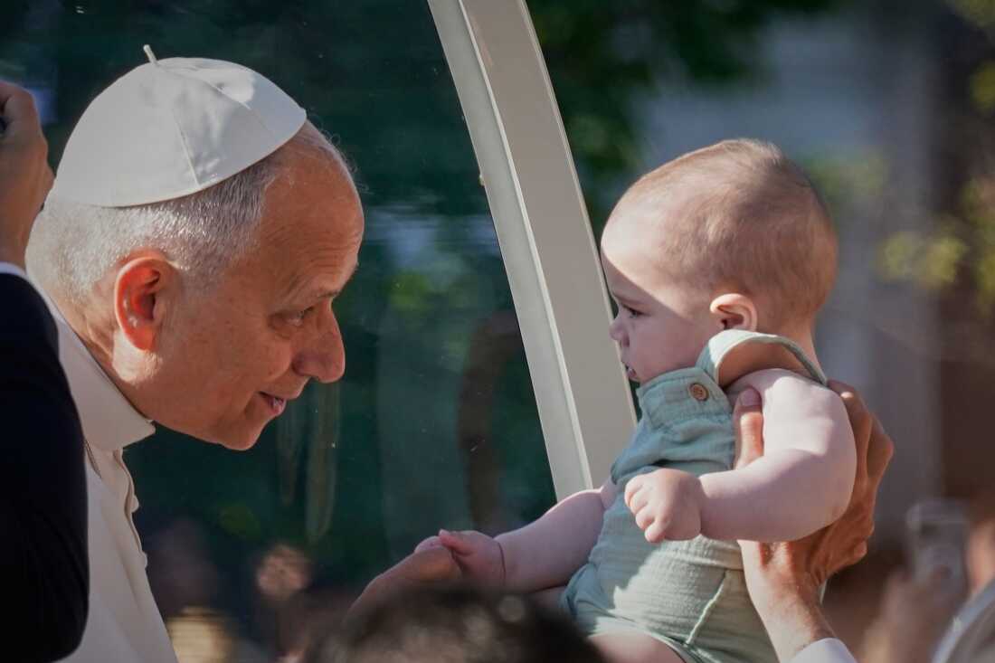 Pope Leo XIV greets a child upon arriving in the popemobile at Plaza de Cibeles for a Holy Mass and Corpus Christi procession in Madrid, Spain, Sunday, June 7, 2026, on the second day of his seven-day apostolic visit to mainland Spain and the Canary Islands.