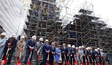 Colorful streamers fall as church and civic officials, including senior pastor Dr. Robert Jeffress and his wife Amy  (center) shovel sand during the First Baptist Church Dallas groundbreaking ceremony for its historic sanctuary in downtown Dallas, June 7, 2026. Scaffolding surrounds what was left of the sanctuary after the devastating fire in 2024.