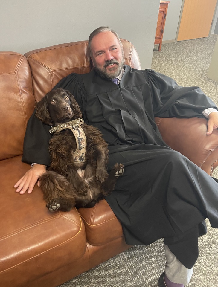 Judge John Roach Jr. and his dog, Justice. Roach is the judge  overseeing the Karmelo Anthony trial. 