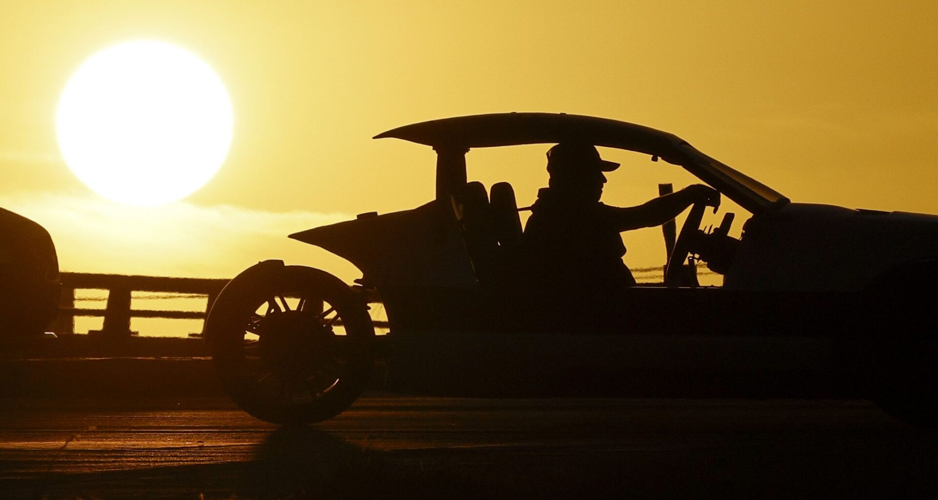 A motorist drives a Polaris Slingshot as the sun sets behind Interstate 35W near Basswood Boulevard, Wednesday, Feb. 18, 2026, in Fort Worth.