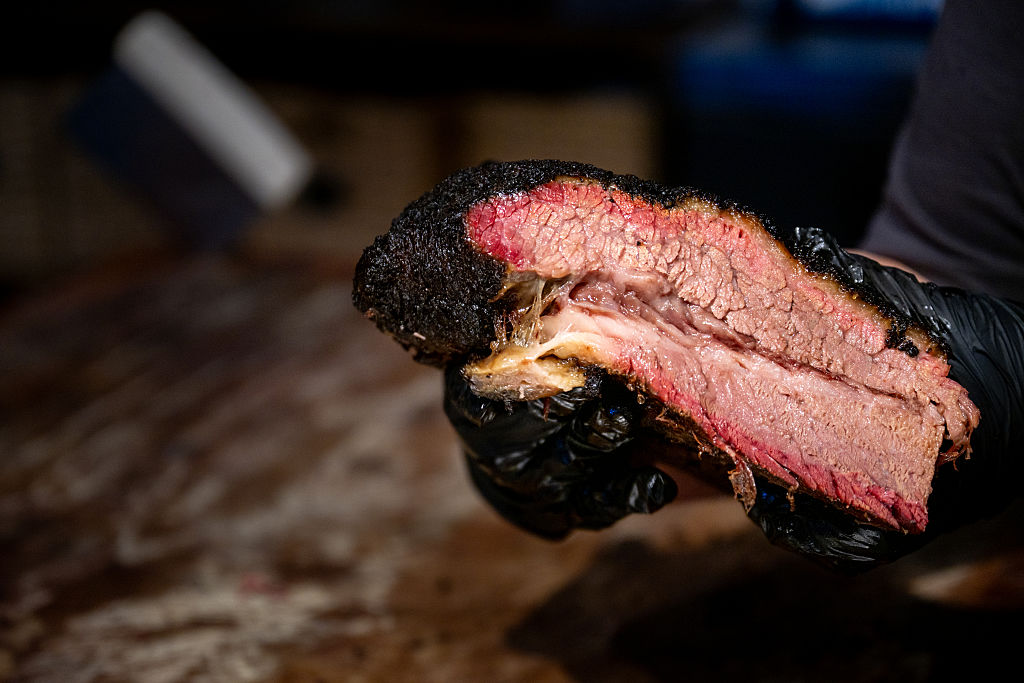 An employee showcases a brisket at a Terry Black's Barbecue restaurant on May 27, 2026 in Lockhart, Texas.
