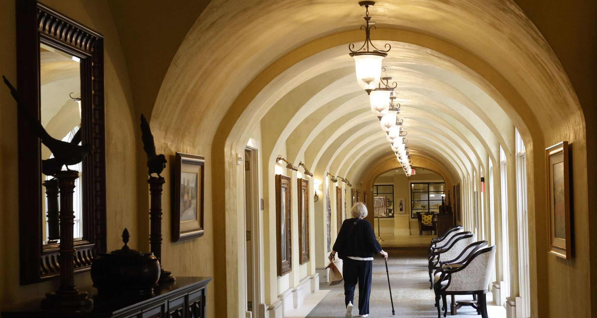A woman walks in a hallway at Edgemere, senior living community, Friday, May 1, 2026, in Dallas.