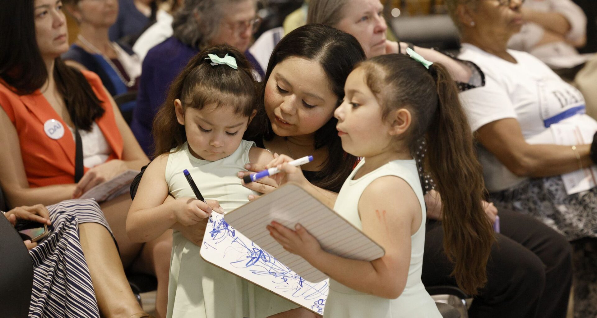 Adara Cruz, center, attends a news conference to launch Dallas Childcare Works with her children Adelina Cantu, 3, left, and Amelia Cantu, 6,   at First Presbyterian Church of Dallas,Thursday, May 28, 2026, in Dallas.