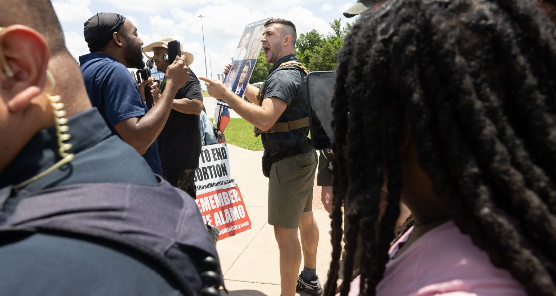 Jake Lang is removed by police for violating decorum rules while speaking in opposition to the proposed construction of a mosque and two temples during a city council meeting in Frisco, Tuesday, May 19, 2026.