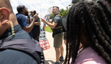 Jake Lang is removed by police for violating decorum rules while speaking in opposition to the proposed construction of a mosque and two temples during a city council meeting in Frisco, Tuesday, May 19, 2026.
