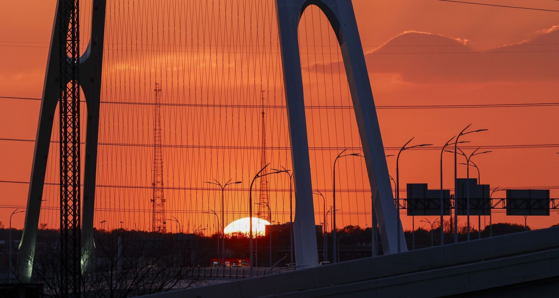 The sun sets behind Interstate 30 and Oak Cliff, Friday, March 6, 2026, in Dallas.