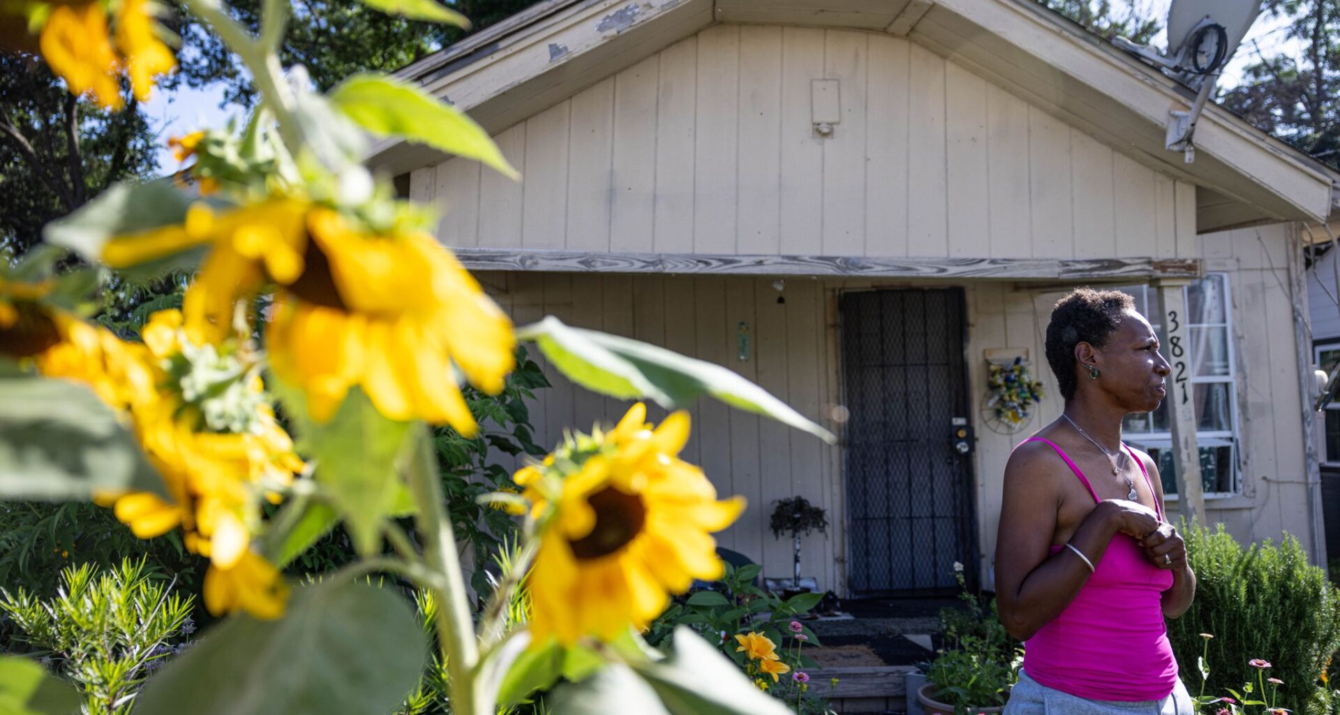 Angella Martin stands in the garden in her front yard and talks about changes in the Queen City neighborhood of Dallas, Tuesday, June 9, 2026.