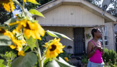 Angella Martin stands in the garden in her front yard and talks about changes in the Queen City neighborhood of Dallas, Tuesday, June 9, 2026.