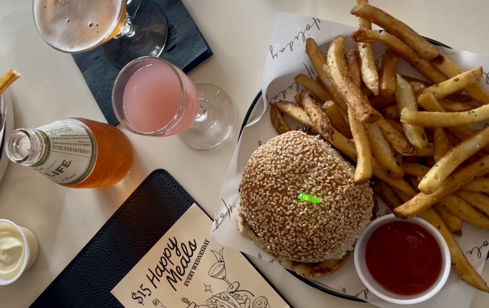 Holiday, a bar and restaurant on East Seventh Street in Austin, hosts happy meal nights every Wednesday, where guests can order a single-patty Wagyu smashburger, a side of fries and their choice of a mini Spaghett or Cosmopolitan cocktail for $15.