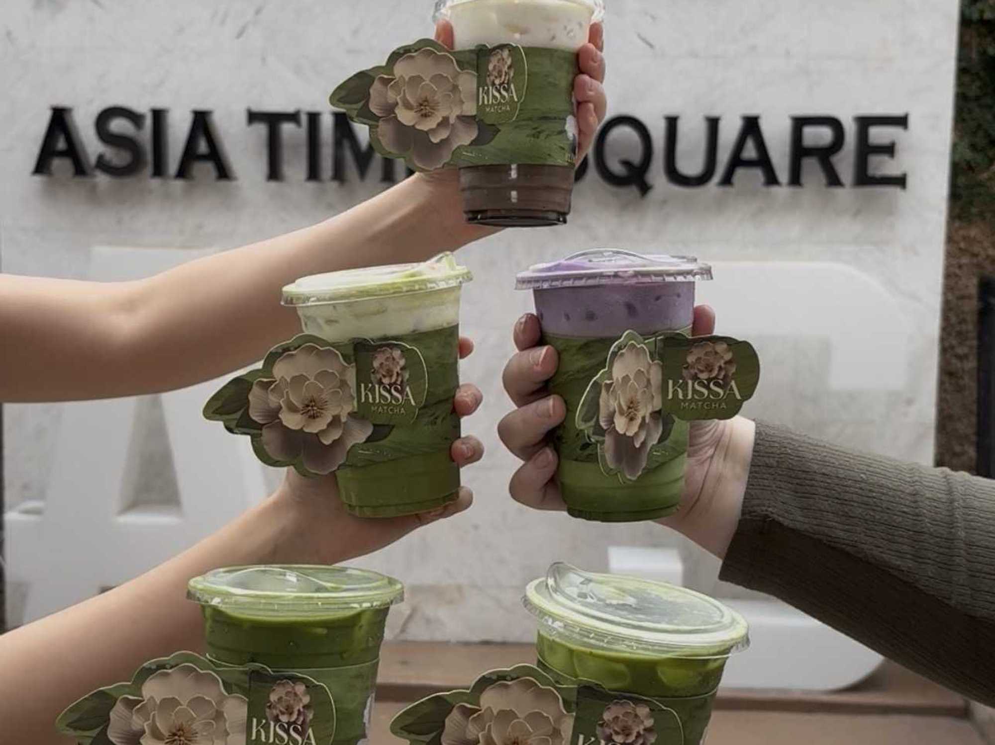 An assortment of iced matcha specialty drinks from Kissa Matcha, served in custom floral cup sleeves.