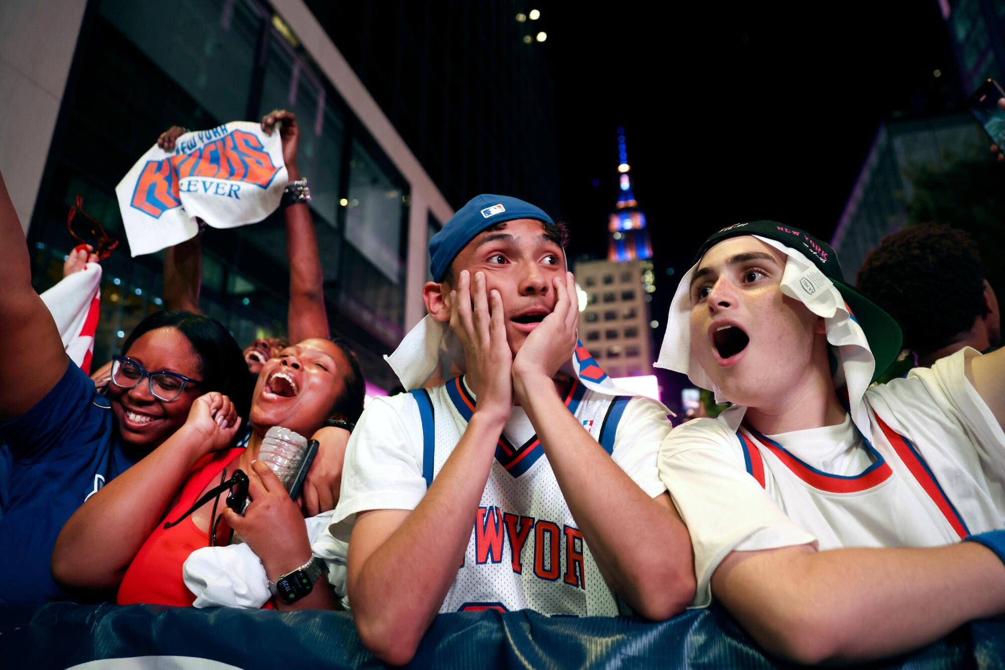 Knicks fans react in New York after the team's title-clinching win over the Spurs on Saturday night.