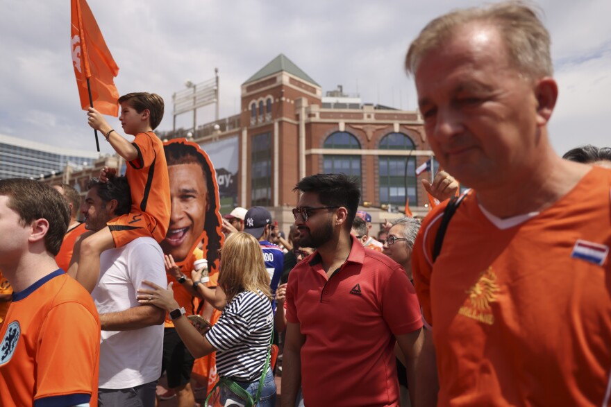 Dutch fans march past Choctaw Stadium for the Orange Army March before the Netherlands and Japan World Cup game Sunday, June 14, 2026, in Arlington.