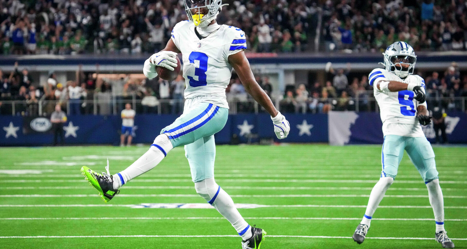 Dallas Cowboys wide receiver George Pickens (3) runs through the end zone after catching a long pass for a second quarter touchdown against Los Angeles Chargers safety Derwin James Jr. (3) at AT&T Stadium in Arlington, December 21, 2025.