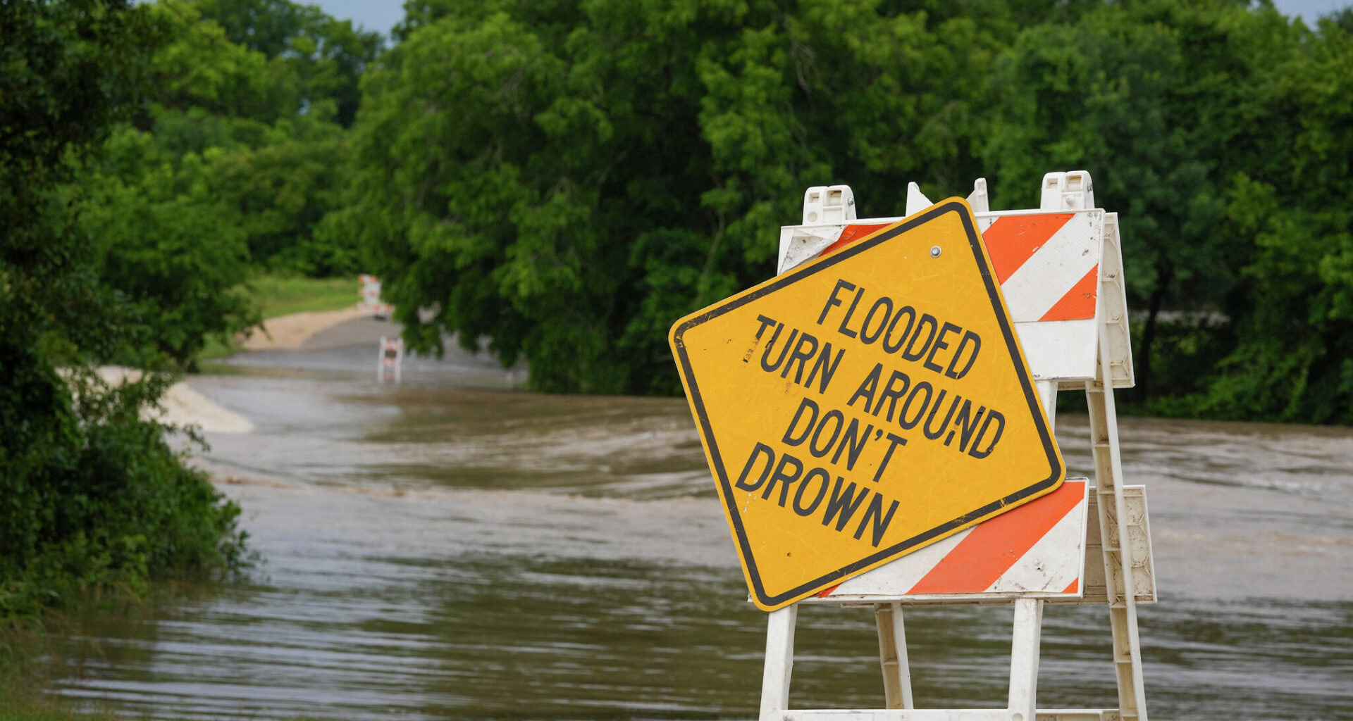 Is it legal to drive around flooded road barricades in Texas?