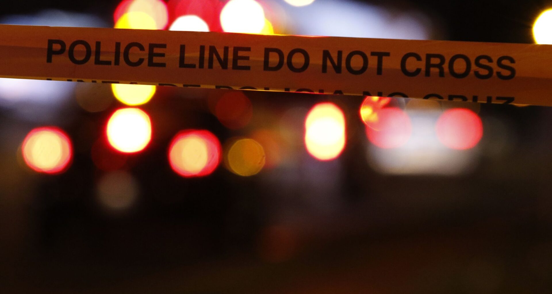 Police tape cuts off a crime scene.