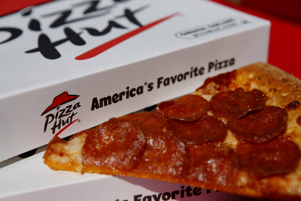 A pepperoni pizza from a Pizza Hut restaurant, a unit of Yum! Brands Inc., is arranged for a photograph in Torrance, California, U.S., on Monday, Oct. 7, 2013. ORG XMIT: 183740169