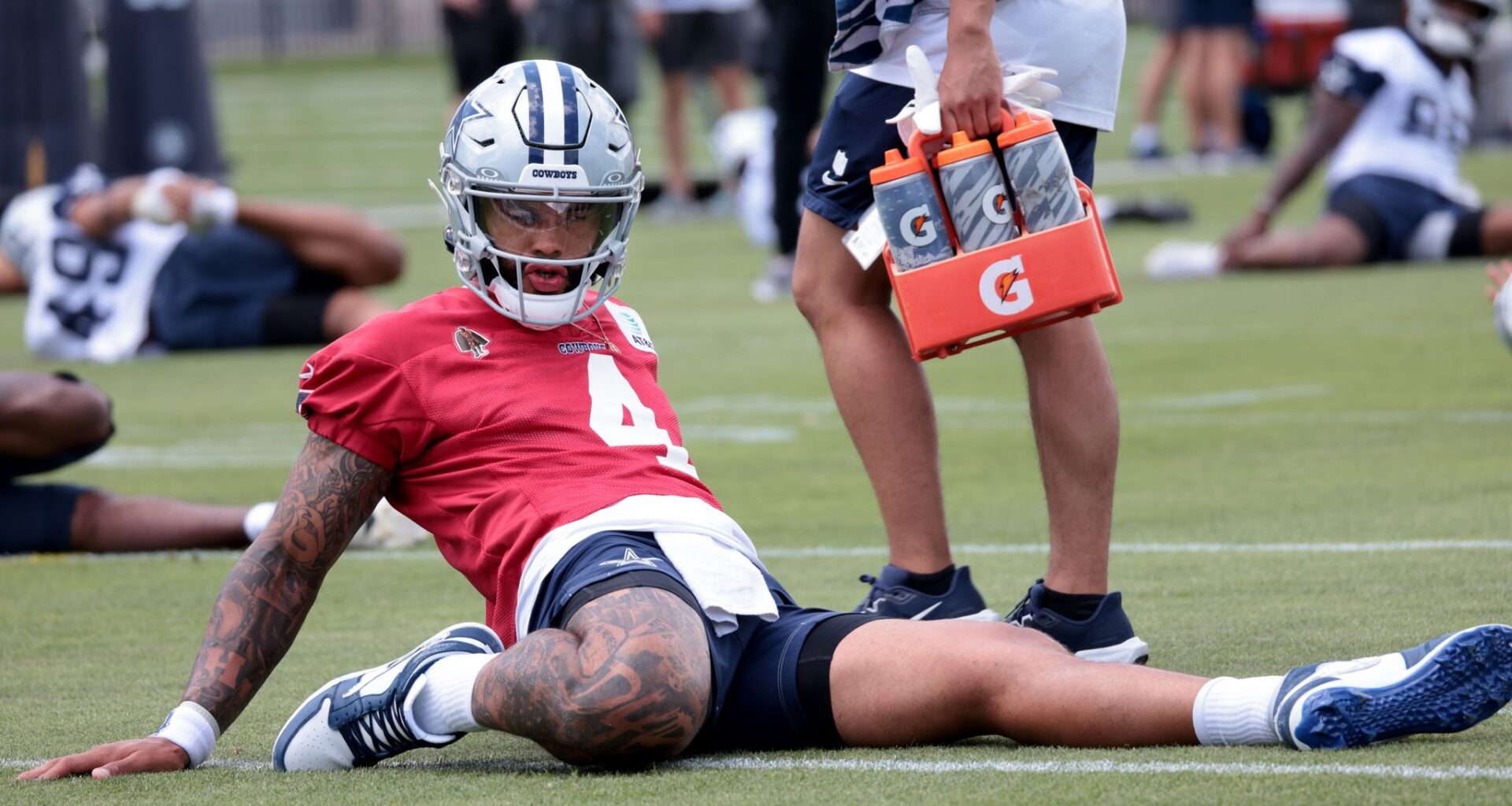 With his personal goals tattooed on his forearm, Dallas Cowboys head coach Brian Schottenheimer listens to a question from a media member during a press conference prior to the start of team OTA practice sessions held at The Star in Frisco on June 9, 2026.