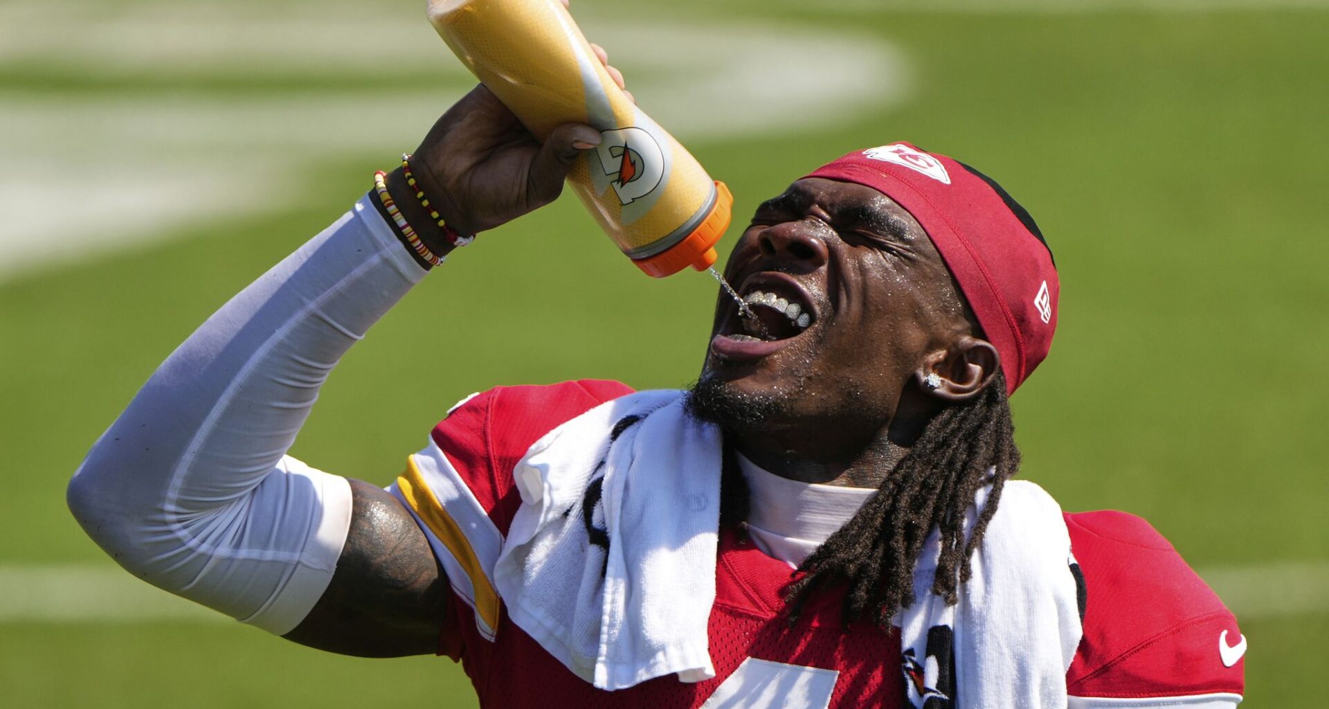 Kansas City Chiefs wide receiver Rashee Rice takes a drink during Back Together Weekend at the team's NFL football training camp, Sunday, July 27, 2025, in St. Joseph, Mo. (AP Photo/Charlie Riedel)