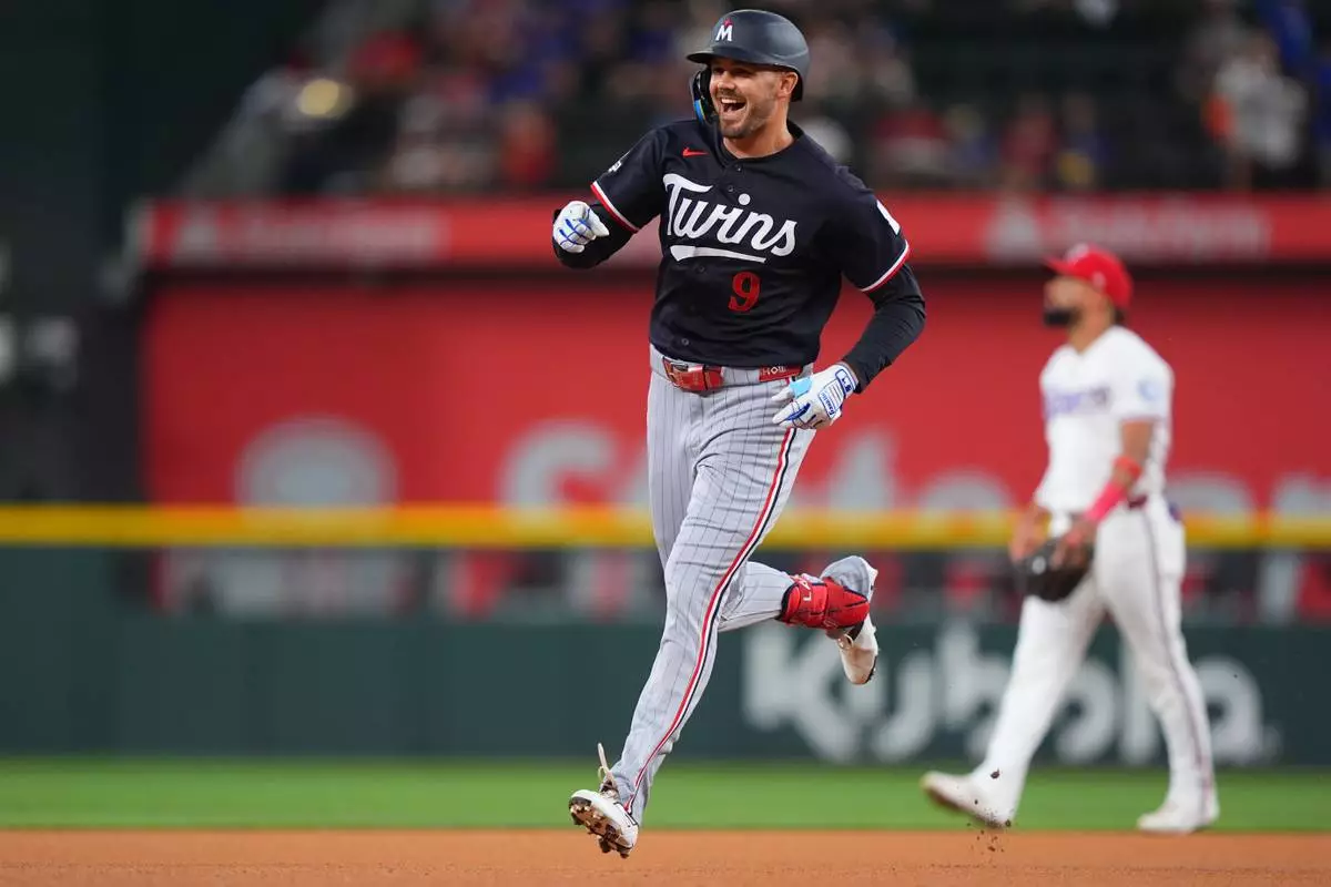 Minnesota Twins' Trevor Larnach runs the bases after hitting a home run during the first inning of a baseball game against the Texas Rangers, Tuesday, June 16, 2026, in Arlington, Texas. (AP Photo/LM Otero)