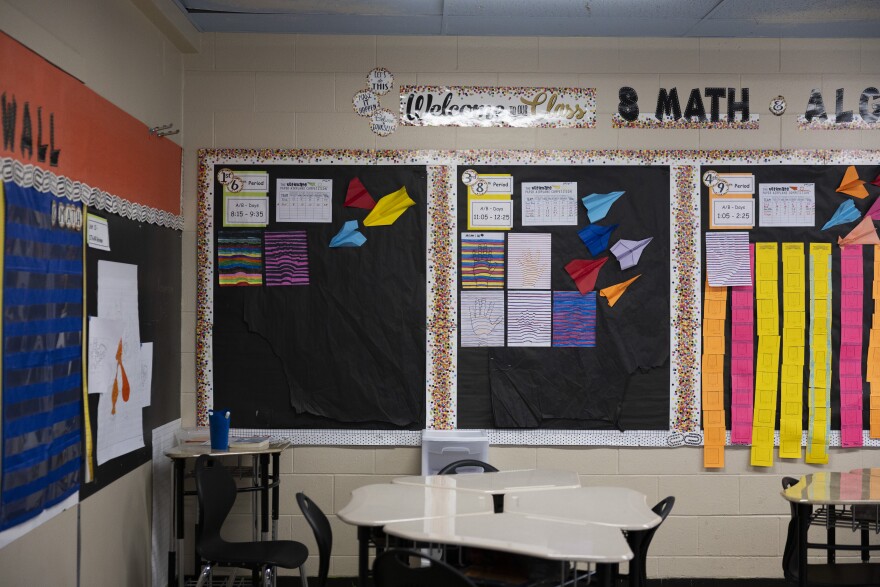 Walls of an 8th grade math classroom decorated with art and colorful paper airplanes.