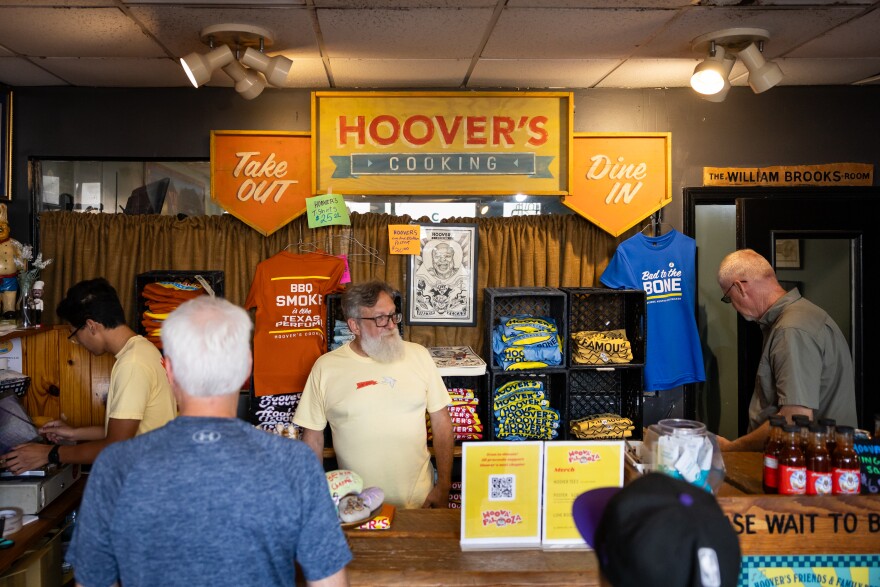 Several people sanding inside of Hoover's restaurant