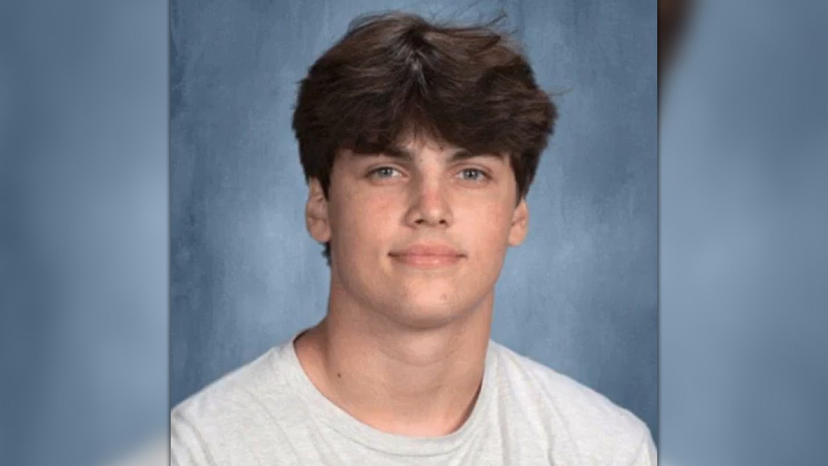 Austin Metcalf standing and smiling