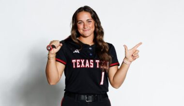 Jayden Heavener holding a cowboy hat on her head for a photo while on a recruiting visit
